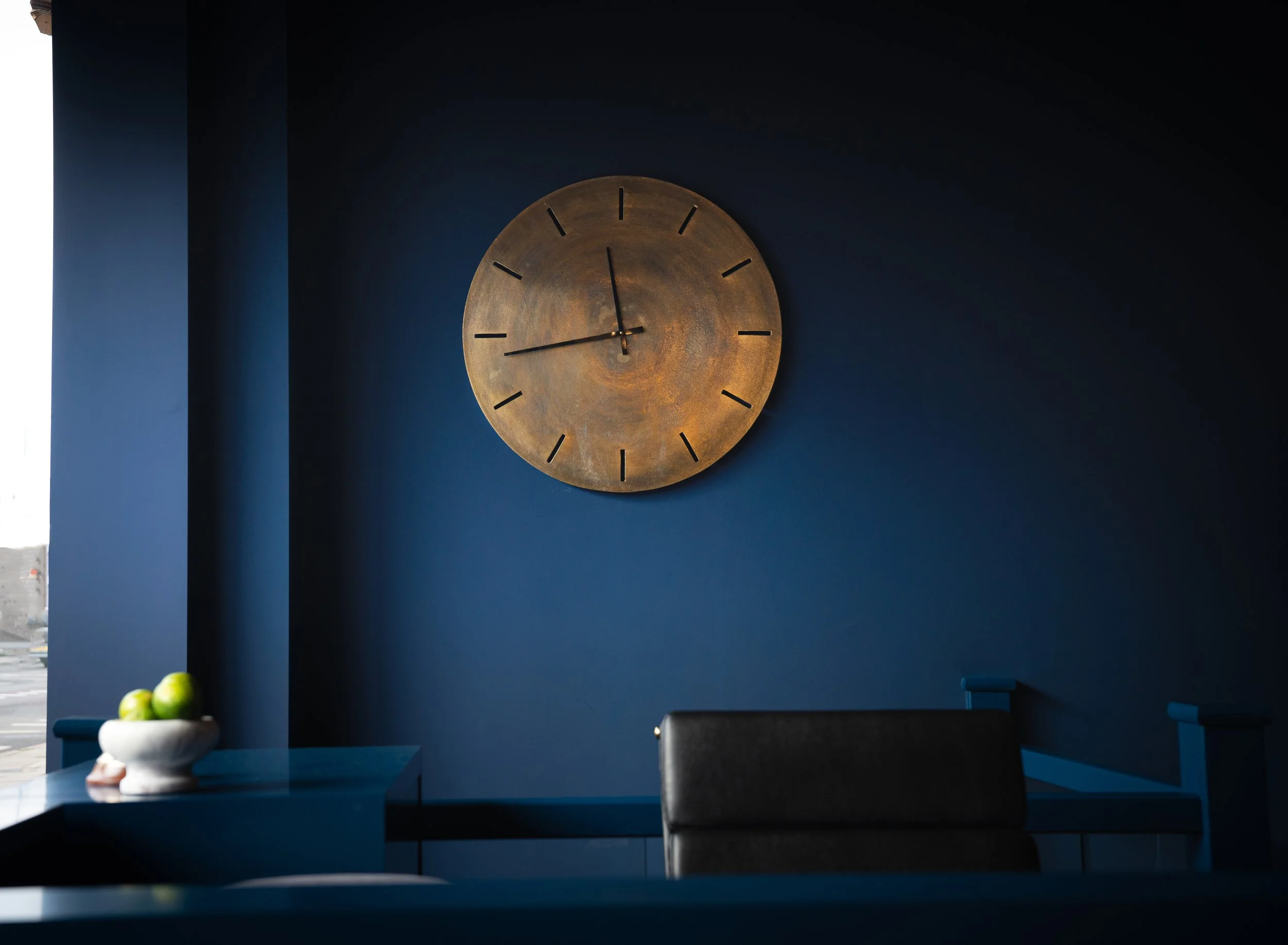 Office wall ideas for office interior design with brass clock on dark blue walls and ceilings by Little Greene