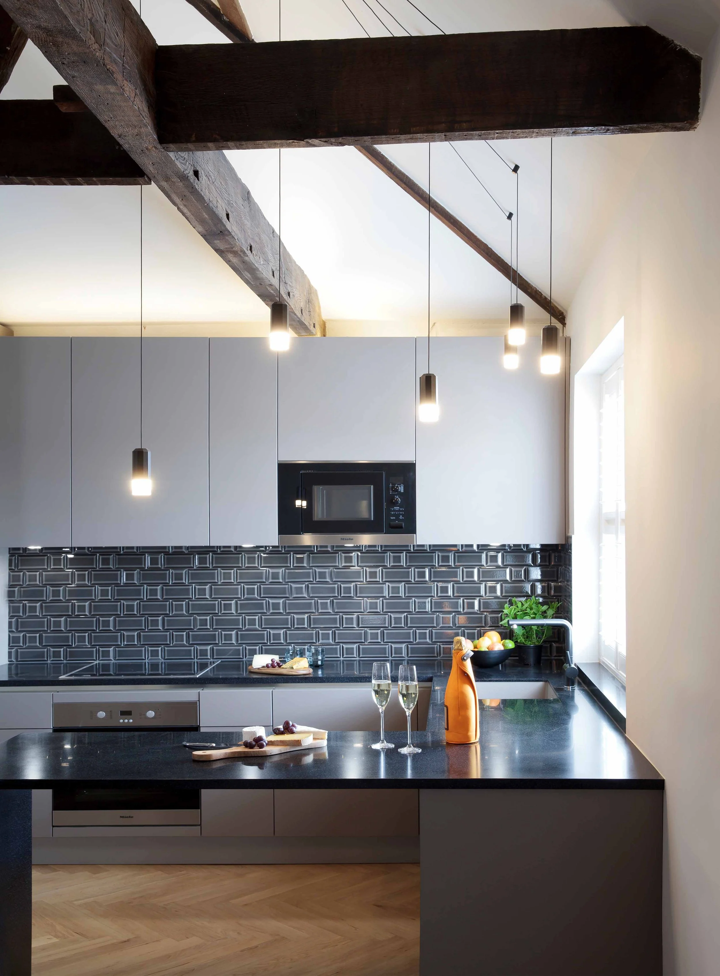 Open-plan kitchen and dining area in the Georgian Twins apartments, showcasing sleek design and functionality.