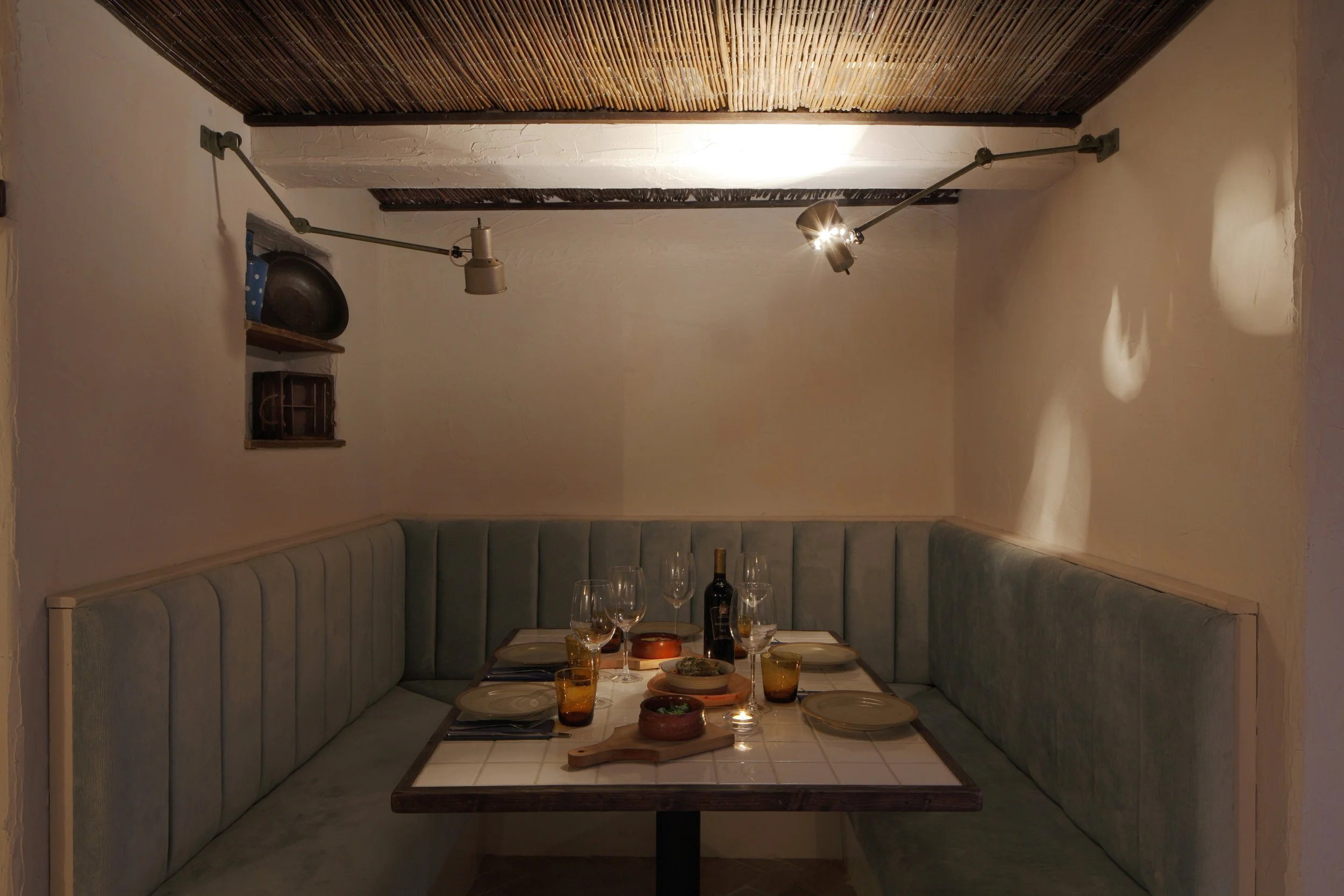 Cozy seating area in Apulia, designed with simplicity and authenticity to reflect 1940s southern Italy.