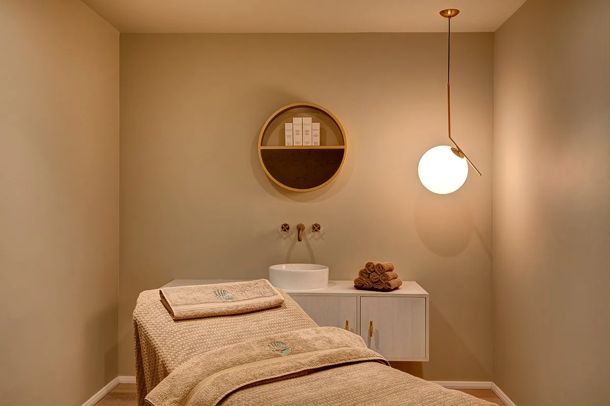 Detail of the spa's interior design, showcasing the calming color palette and premium materials