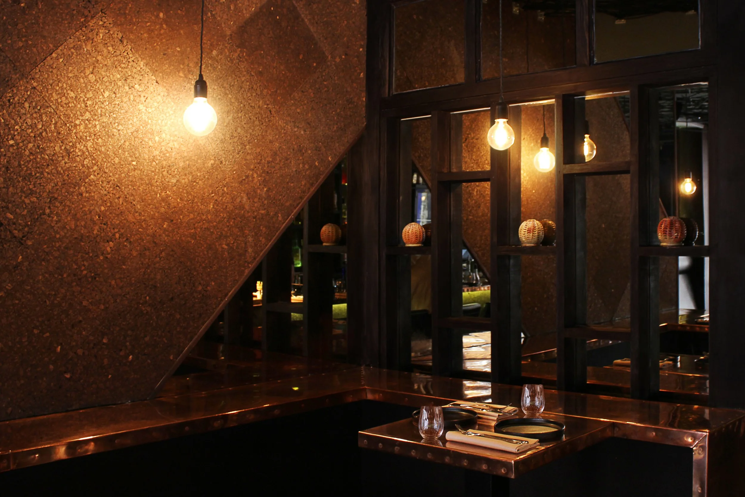 Soft lighting and dark color palette creating an intimate and vibrant dining experience at Duende