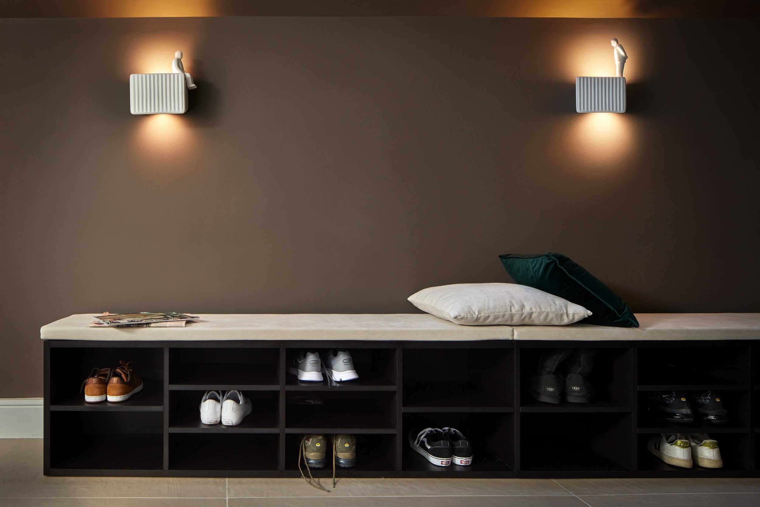 Residential corridor design area with playful lighting from Karman and a stylish bench, designed for functionality and elegance