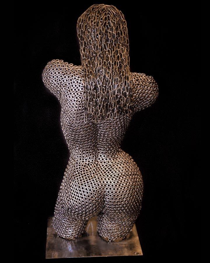 Nuts About You  This  sculpture depicts the  female torso from behind, crafted entirely from welded nuts with delicate chain links forming her flowing hair. A stunning blend of industrial elements and artistic elegance. #SculptureArt #NutsAboutYou #M