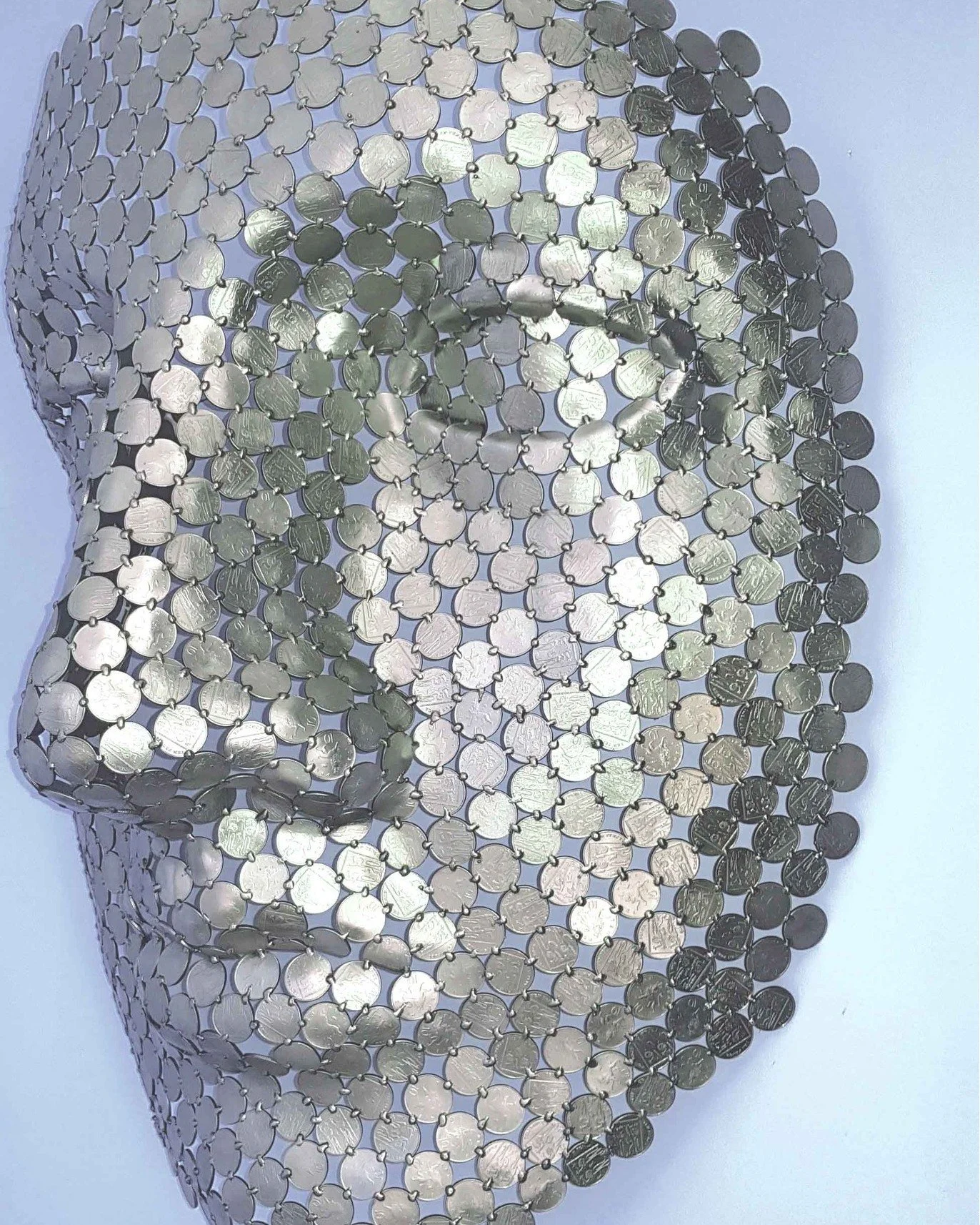 Money In Mind (10p) is constructed through the meticulous welding of hundreds of 10-pence coins, each one shaped and bent to build depth, contour, and quiet expression within the face 

The work explores the relationship between currency, identity, a