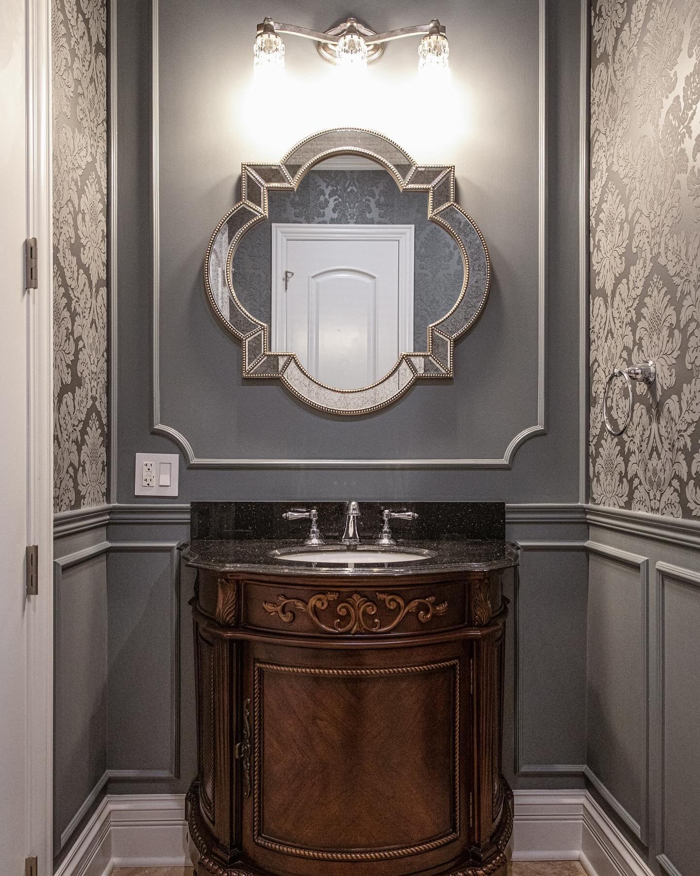 Step into timeless elegance with our Riverwoods bathroom.

Our recent Riverwoods bathroom features a classic wooden vanity with intricate detailing topped with a marble countertop. The distinctively shaped mirror framed in gold adds a touch of elegan