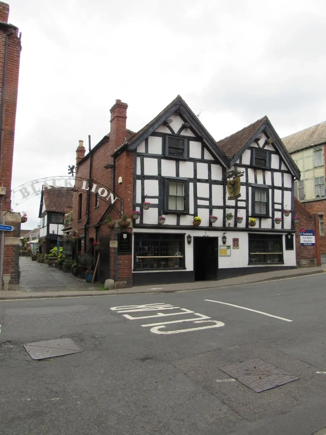 The Black Lion is probably one of Hereford's most famous pubs, and for good reason. As you cross the Old Bridge and make your way up Bridge Street, it arrests your attention with its distinctive black-and-white facade.
Its core dates from the 16th c
