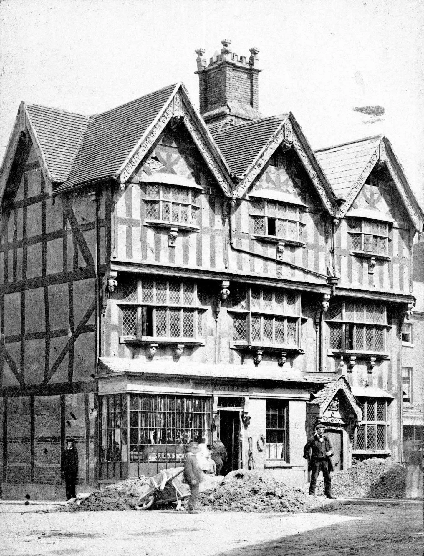 This photograph of the Old House in High Town, Hereford was taken in around 1890, and shows workmen outside who appear to be repairing the road.

Note that the northwest wall is devoid of the windows that adorn it today. The house was once part of a 