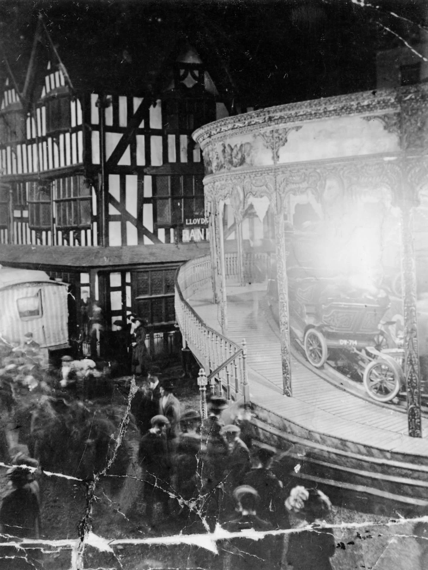 Thought I'd treat you all to another photograph of the Old House today, this time during the 1910 May Fair in Hereford. A very ornate carousel has been erected beside the building's ageing timbers, which are lit up dazzling by ride's electric lights.