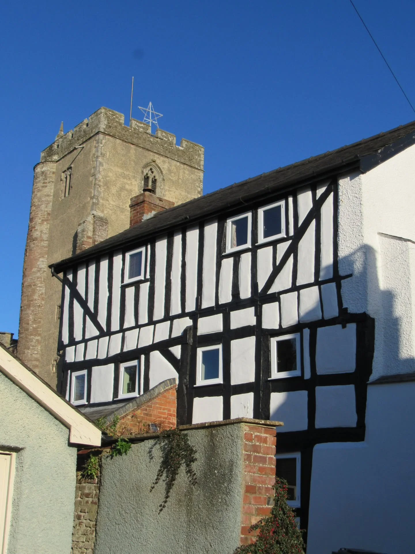 Whilst having a nose around Leintwardine on Boxing Day, this half-timbered building caught my eye as I approached the church. 

It's Number 7, Church Street. The thick box framing dates from the 17th century, and the thinner frames above were added i