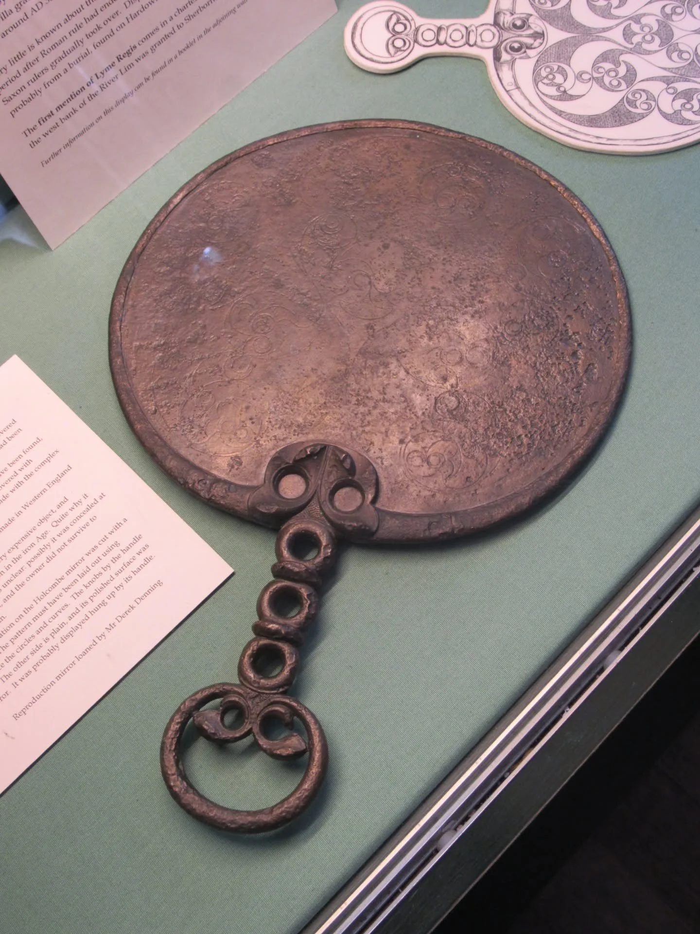 One of my favourite objects on display at Lyme Regis Museum was this Iron Age bronze mirror, known as the Holcombe Mirror.

It was discovered during excavations of the Roman Villa at Holcombe Farm in Uplyme, just to the northwest of Lyme Regis. It wa