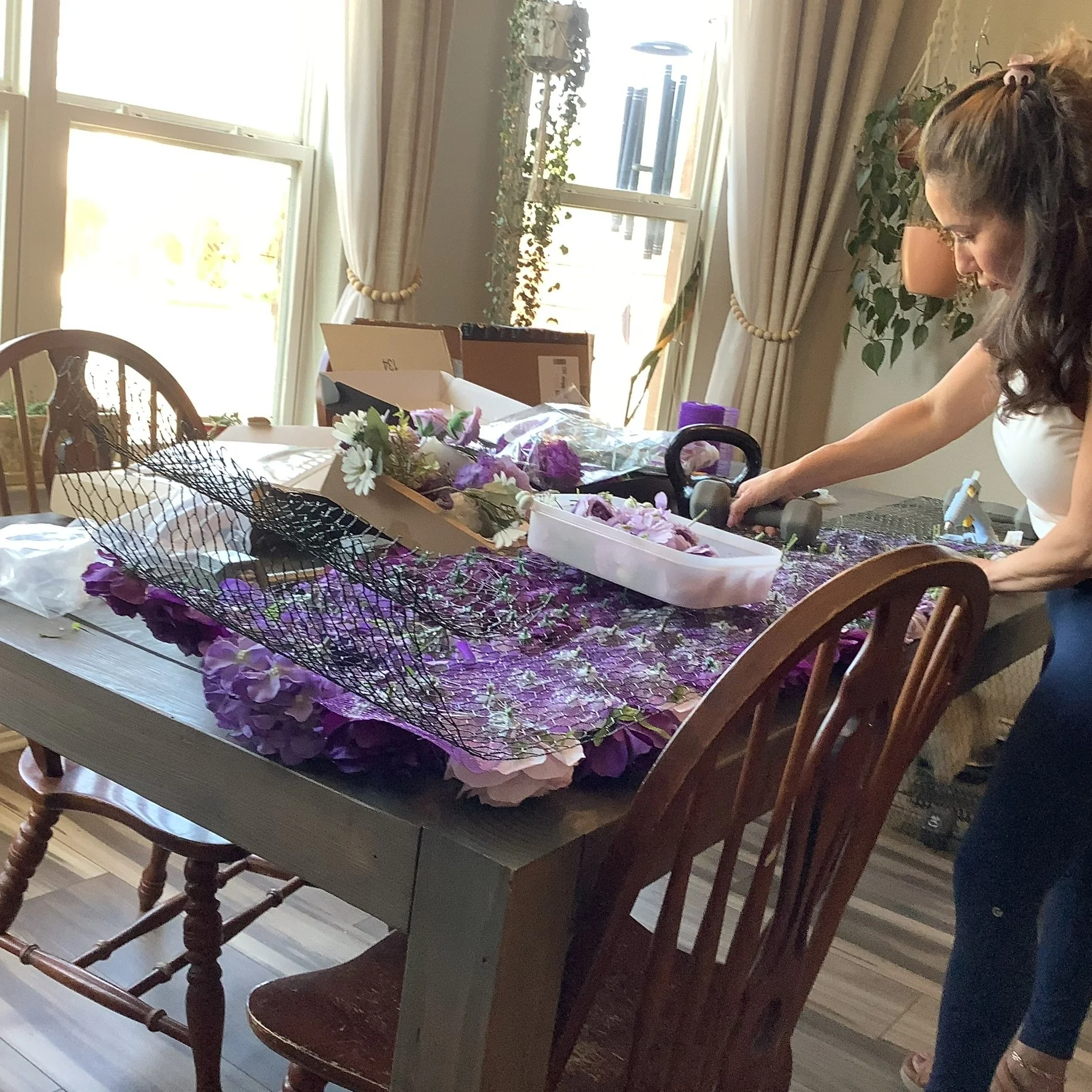 Stephanie creating a large floral installation.