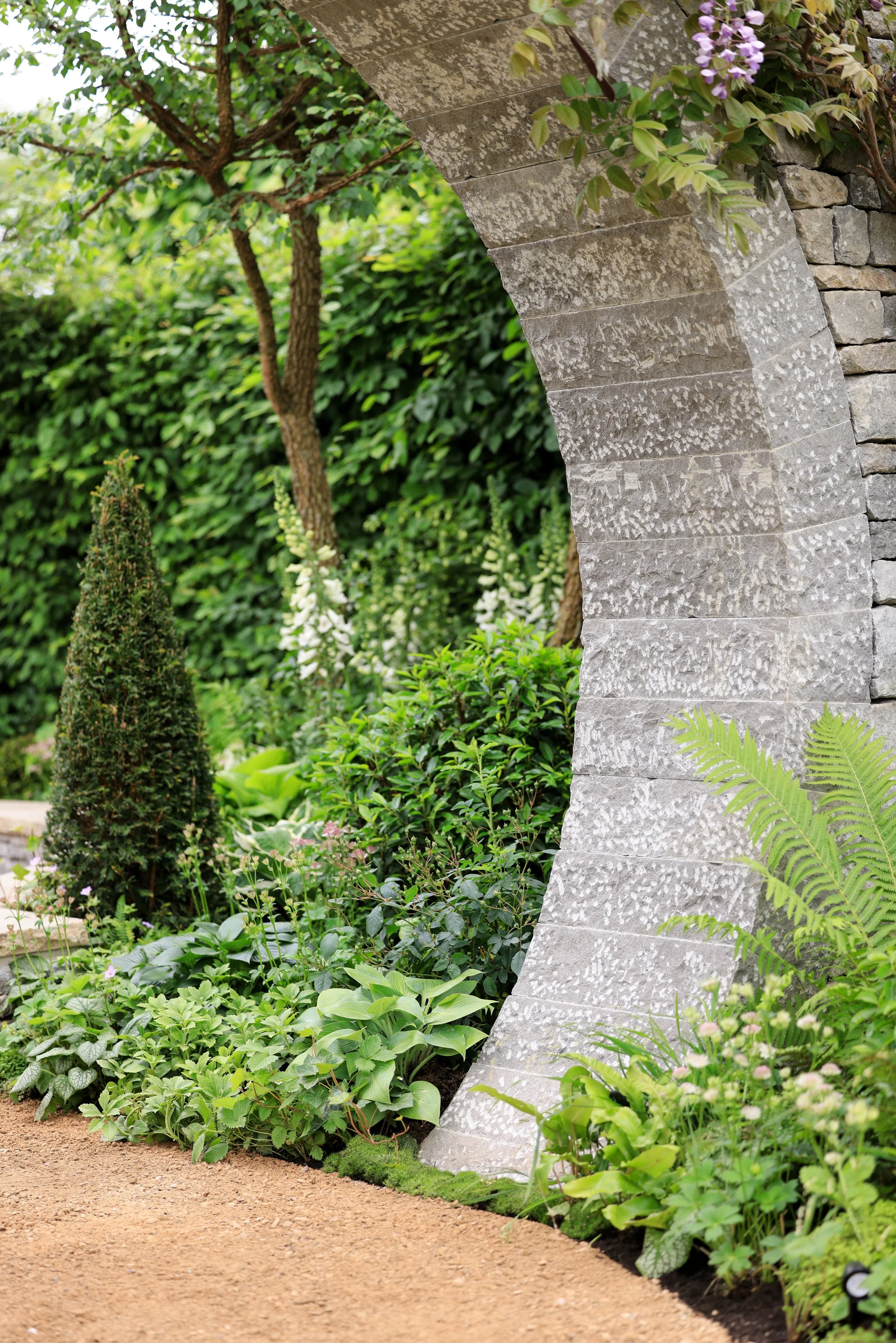 The Bridgerton Garden drystone moongate was designed to act like a portal into the historically inspired space.