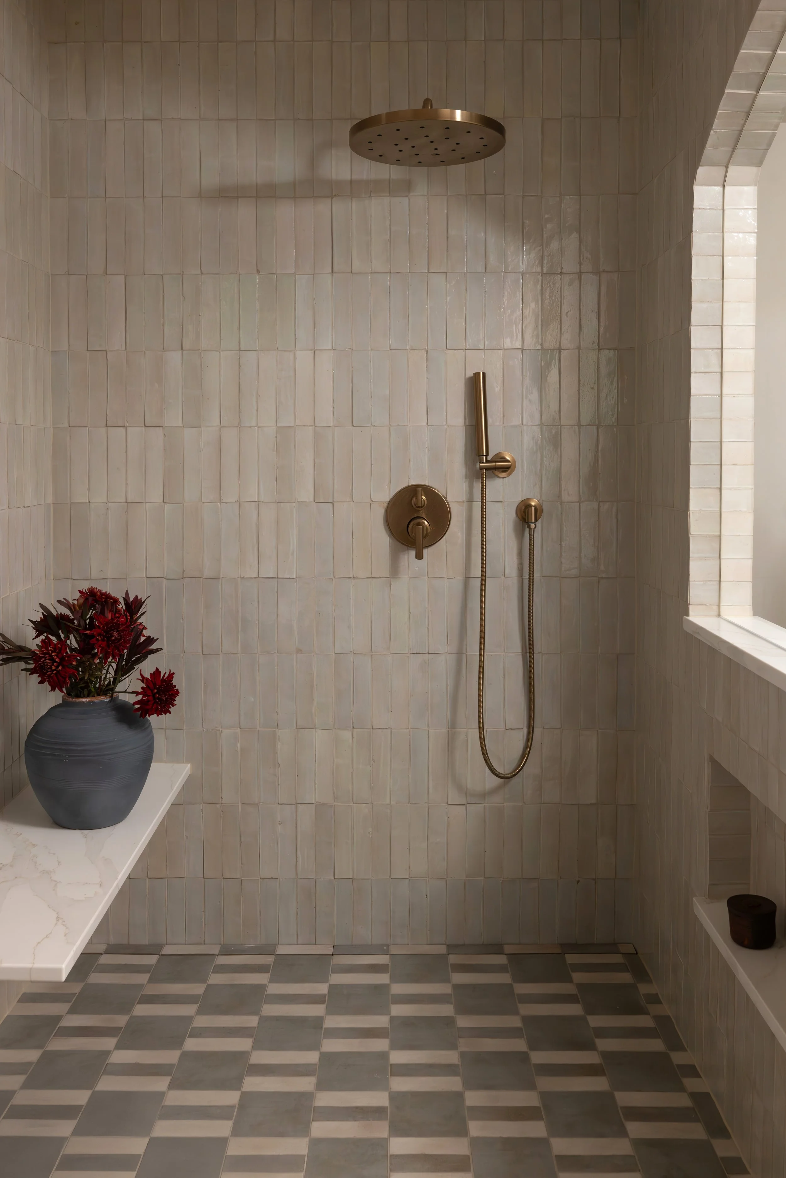 Wet room with neutral tiles and bench