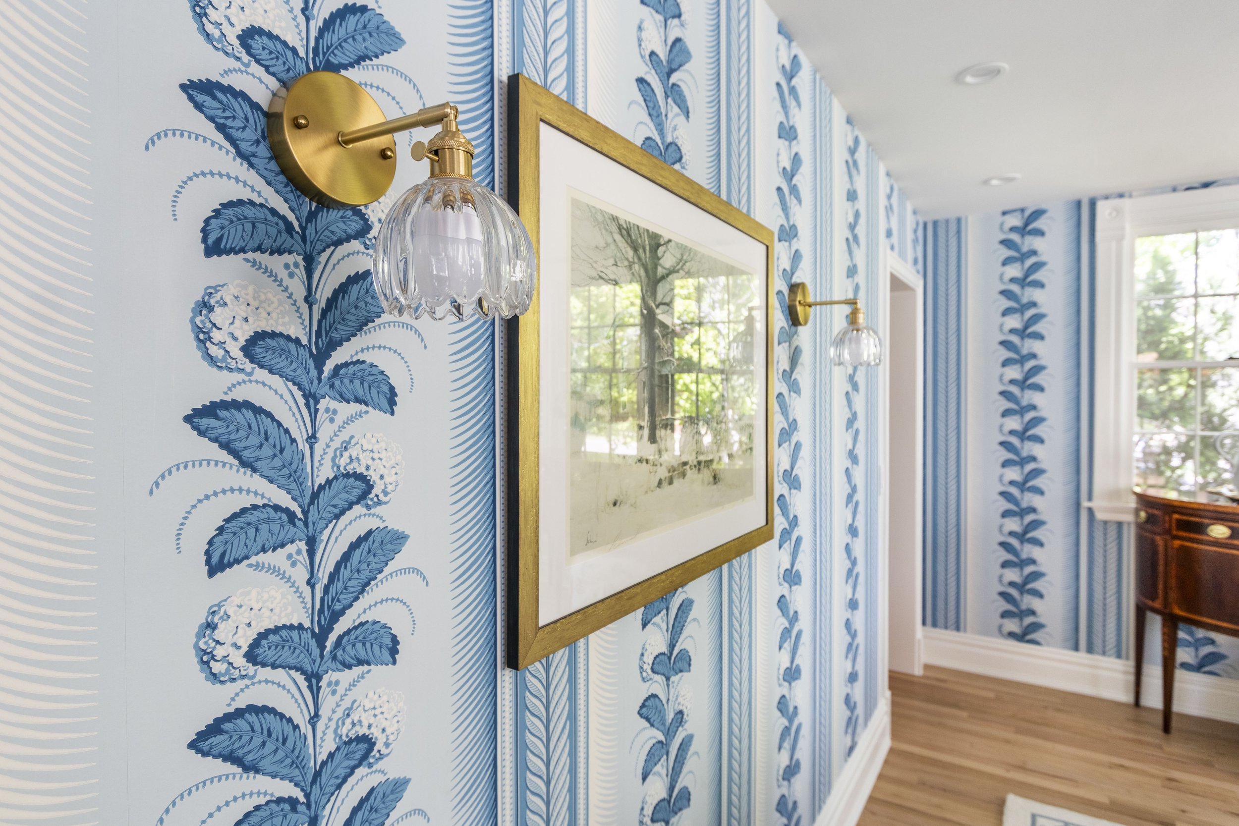 Delicate sconces to add a focus point and mood lighting to this transitional dining room