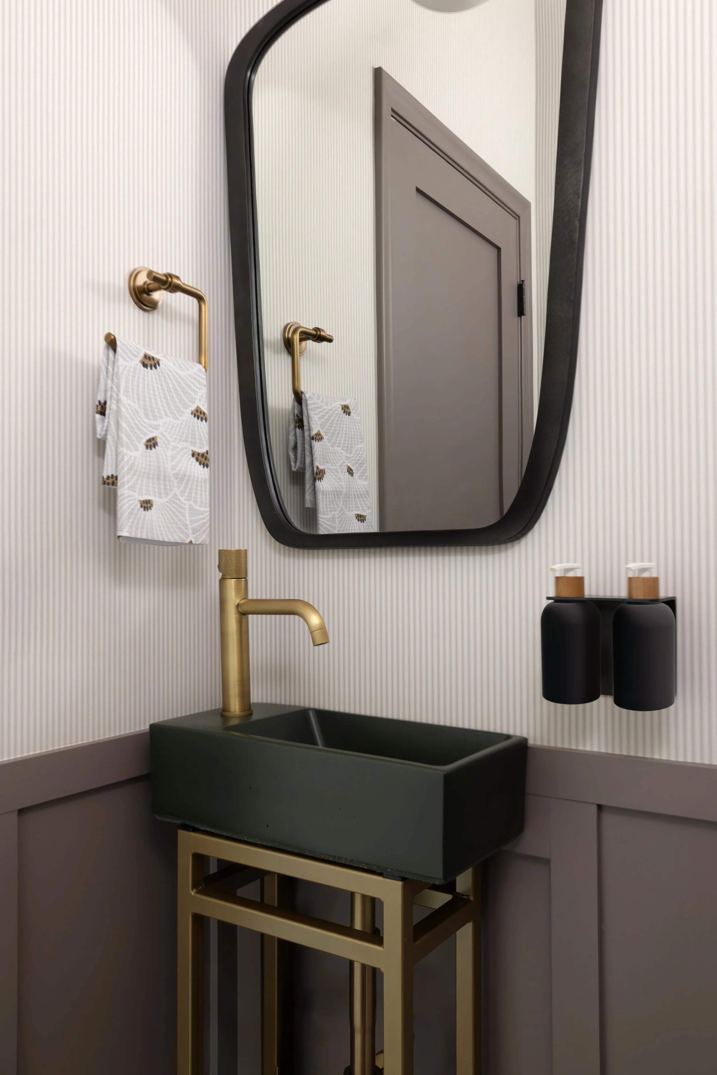 powder bathroom with wallpaper and millwork