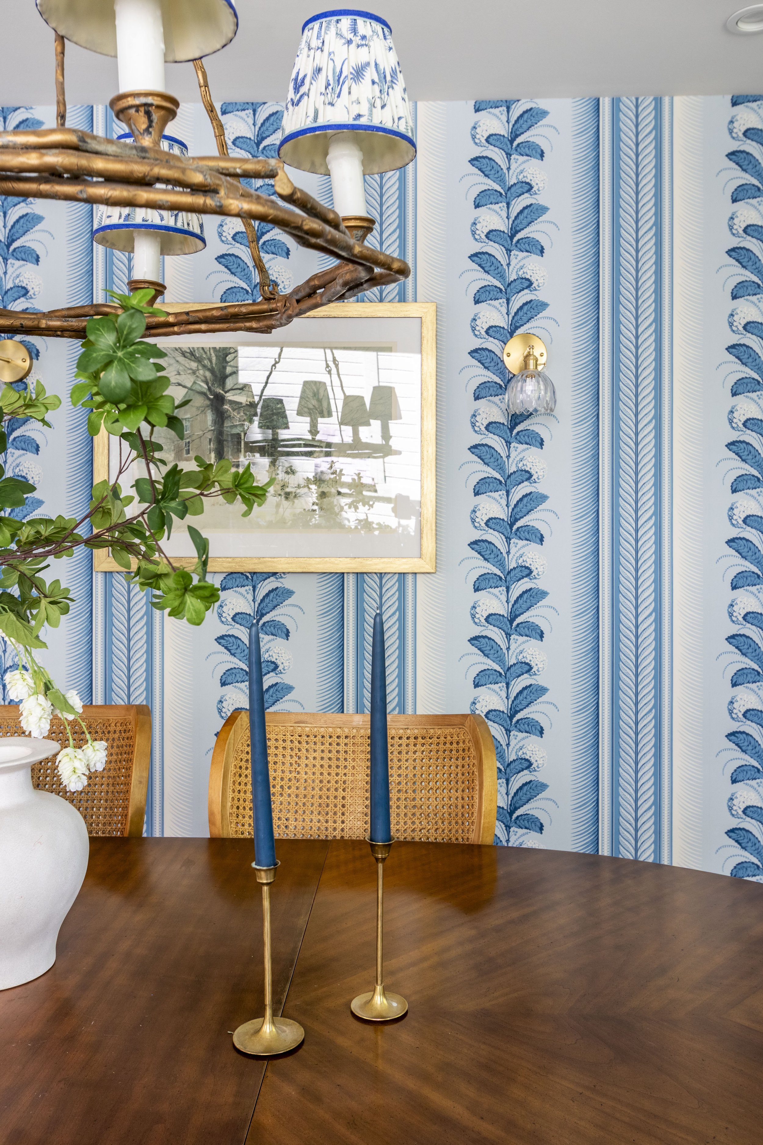 Transitional dining room with fun bright wallpaper and a vintage dining table.