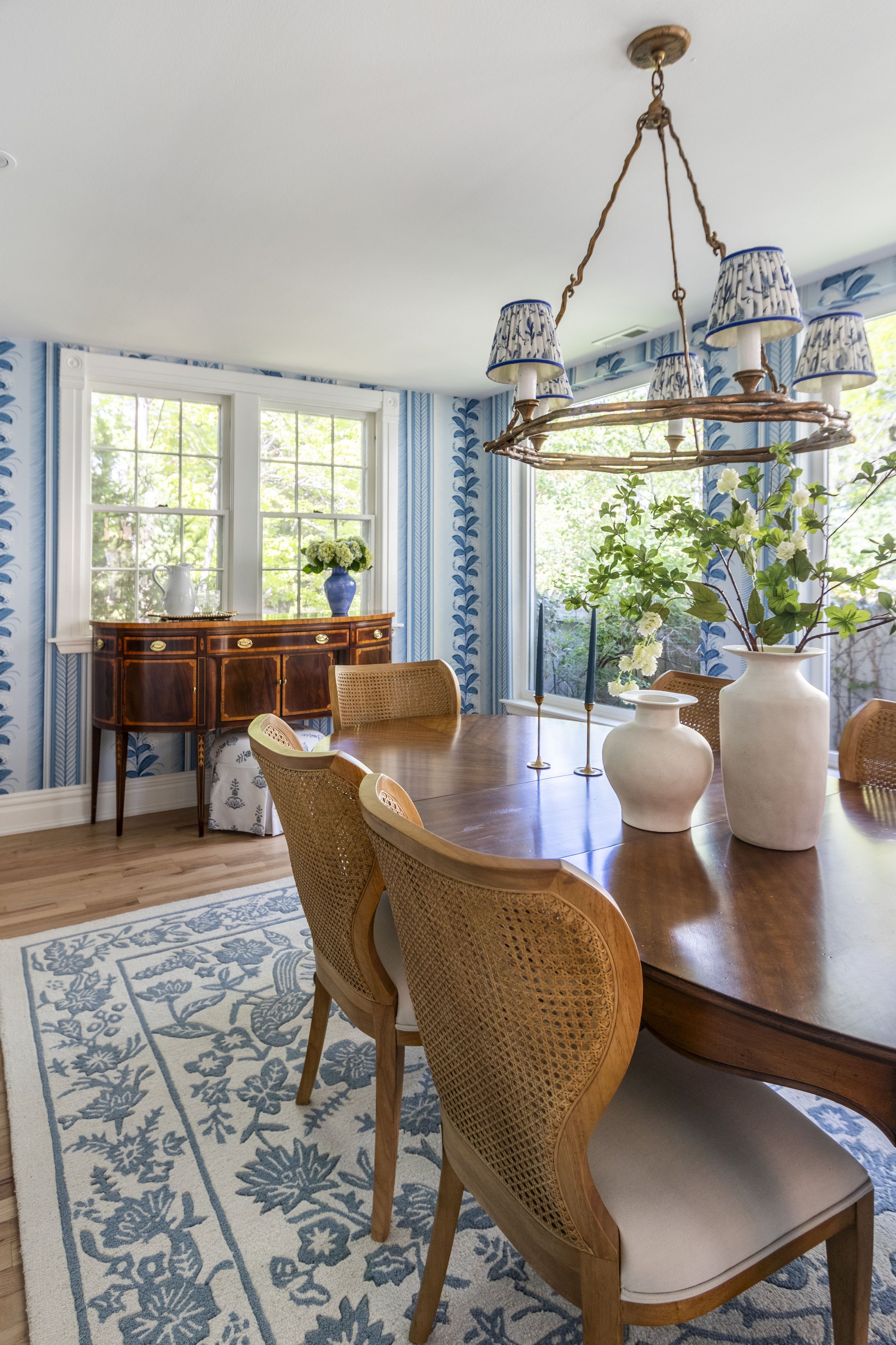 Transitional dining room in Denver Colorado with fun bright wallpaper and a vintage dining and buffet table.