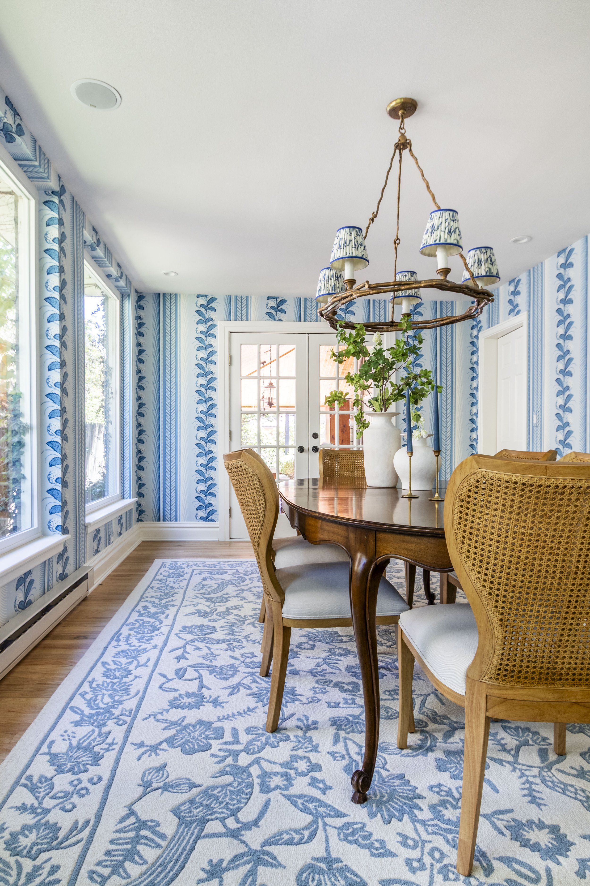 Transitional dining room in Denver Colorado with fun bright wallpaper and a vintage dining table.