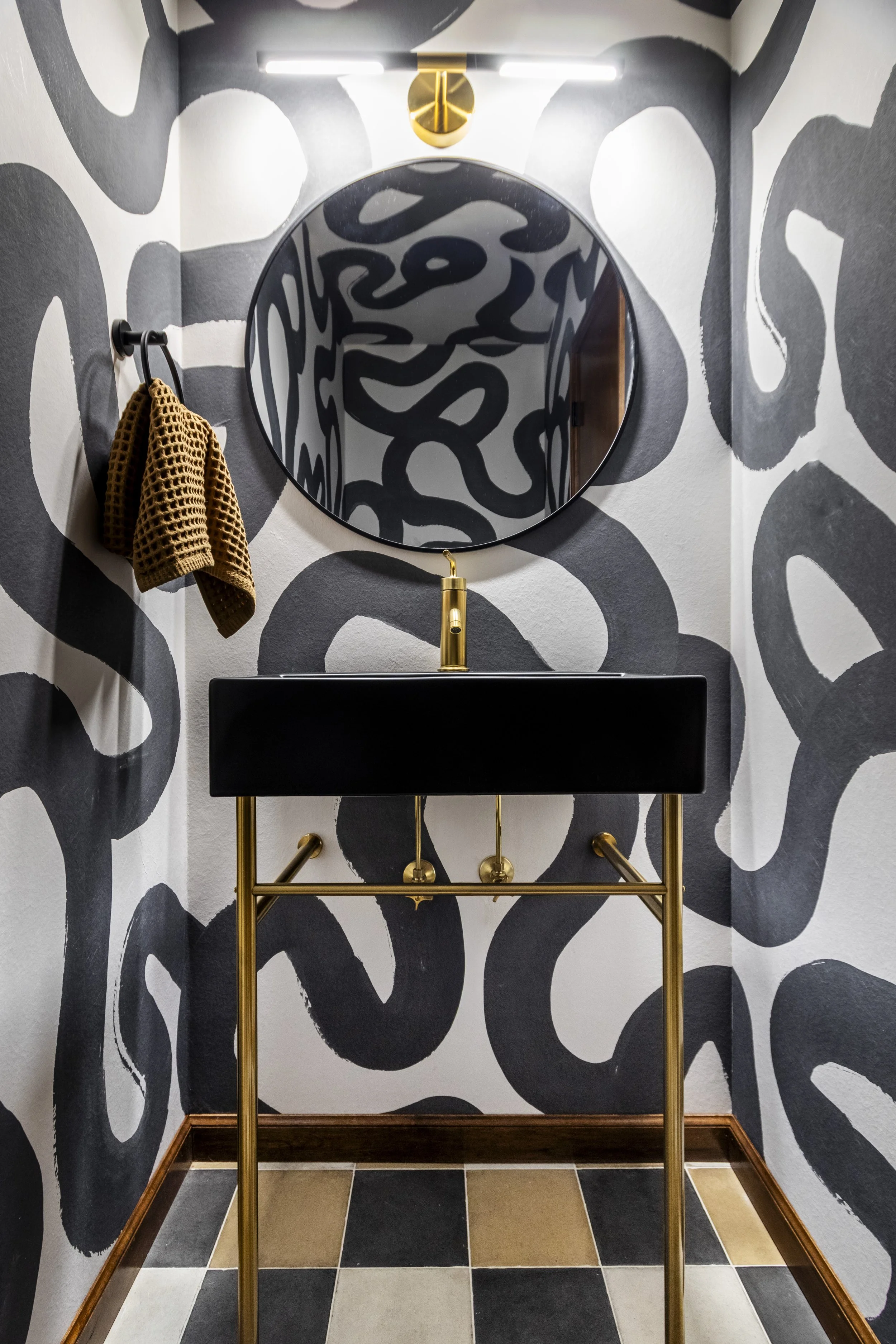 dramatic powder room with abstract wallpaper