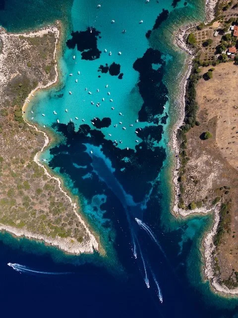 aerial-view-of-a-turquoise-lagoon-with-numerous-bo-2025-03-16-04-35-50-utc.jpg