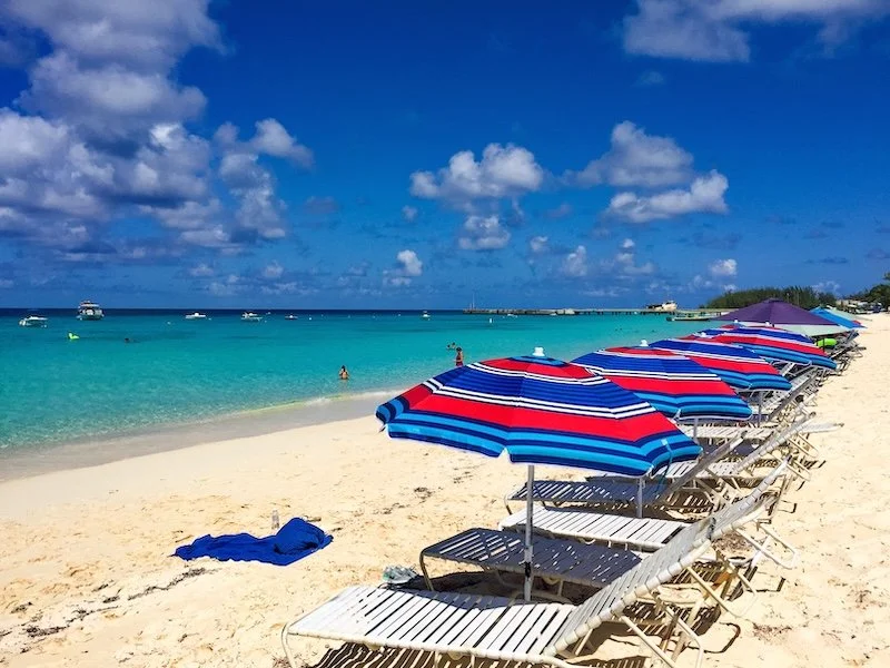 lounge-chairs-with-umbrellas-on-a-sandy-beach-with-2024-12-05-15-17-21-utc.jpg