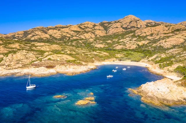 corsica rocky coastline with yachts