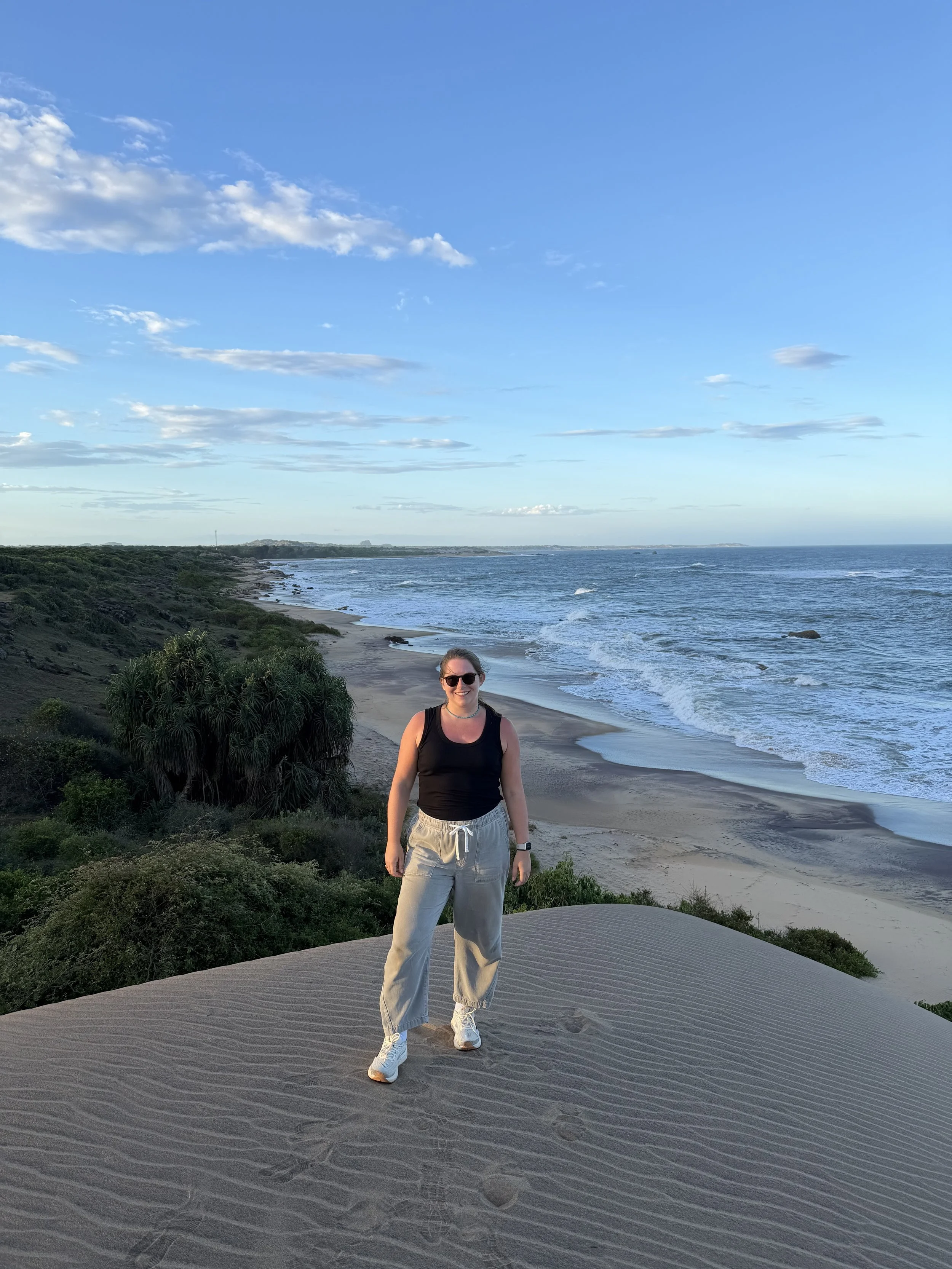 Luxury travel advisor in Sri Lanka, standing along the coastline in Yala National Park.
