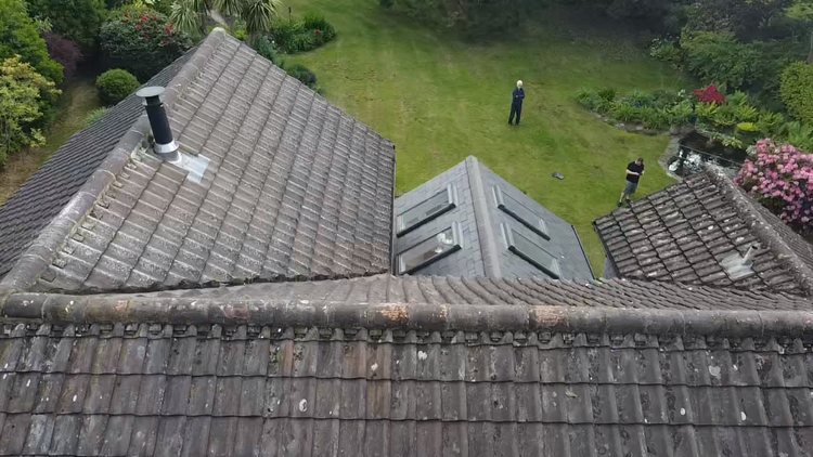 Aerial view of tiled roof slopes, a rooflight and adjoining roof junctions