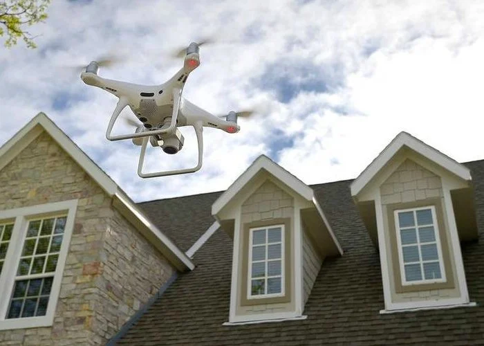 A drone flying above the roof of a house