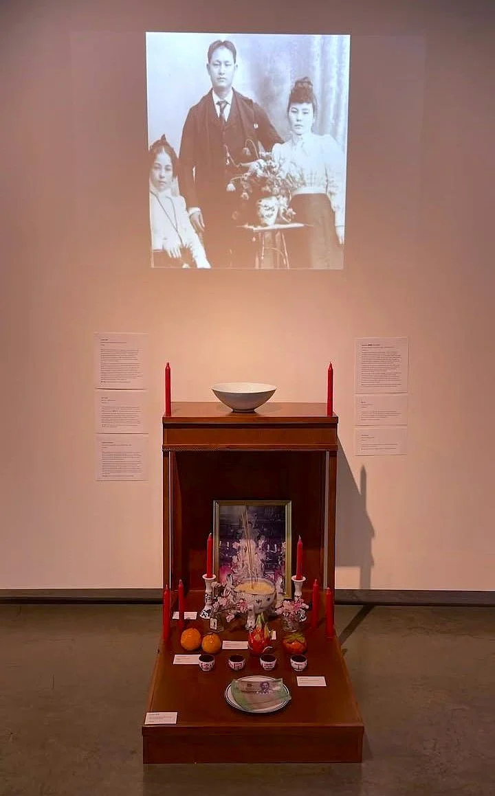 Ancestral Altar as seen at ARTS at King Street Station, alongside a slideshow of Ahmoy's family members.
