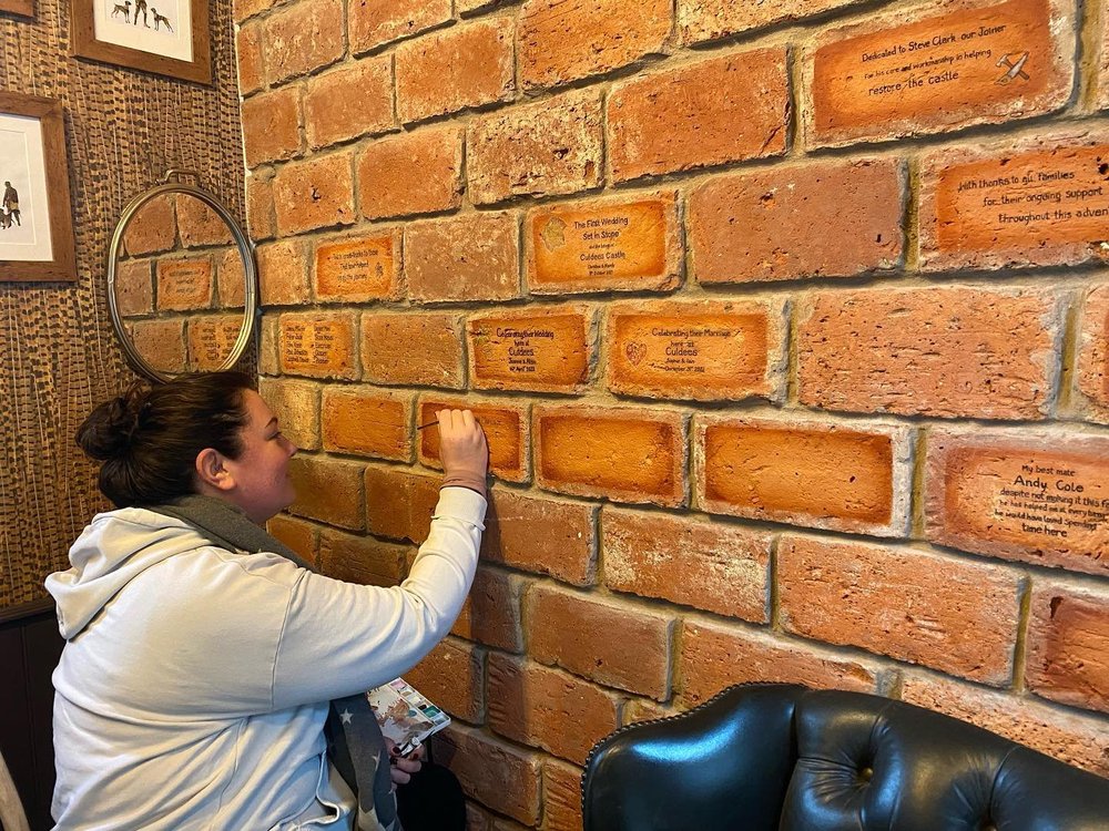 Wedding details being added to the commemorative brick wall at Culdees Castle
