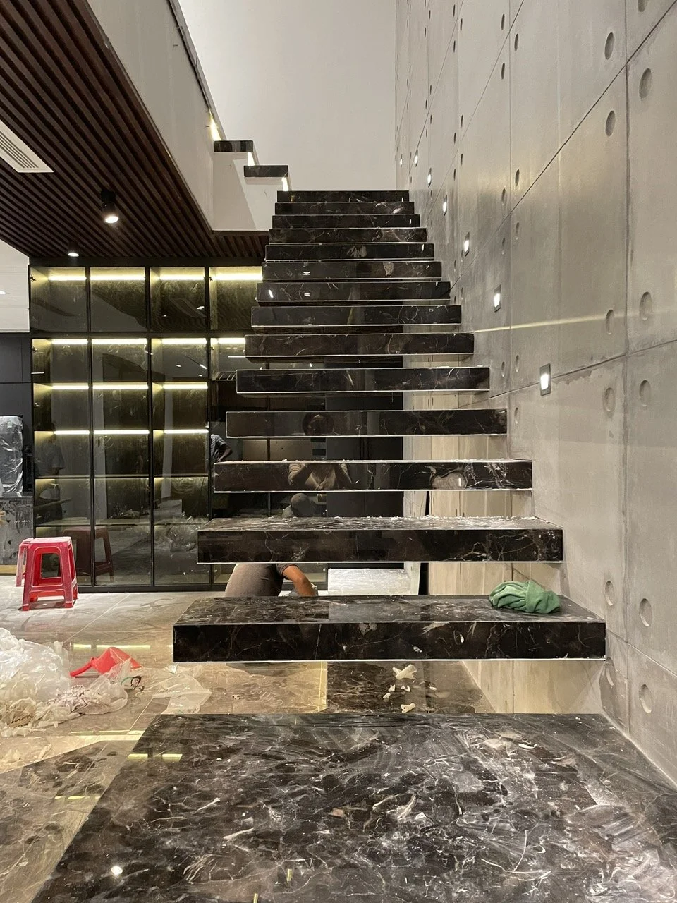 Modern interior with floating black marble stairs and polished floors