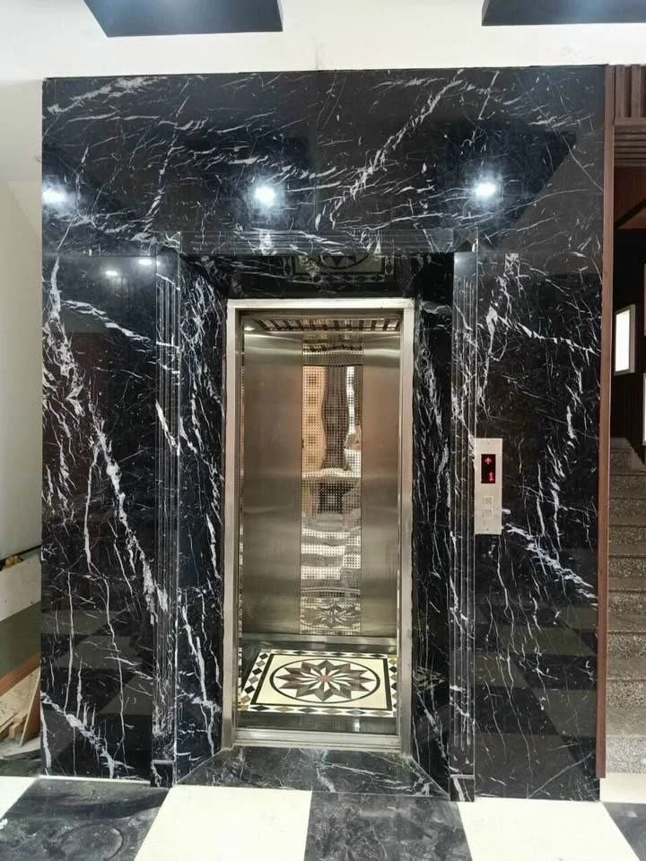 Luxury marble elevator entrance with intricate floor design