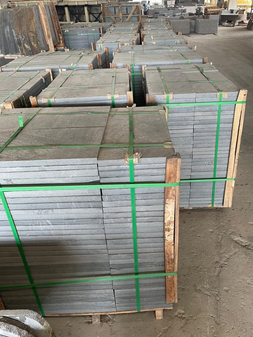 Pallets of stacked stone slabs in a warehouse