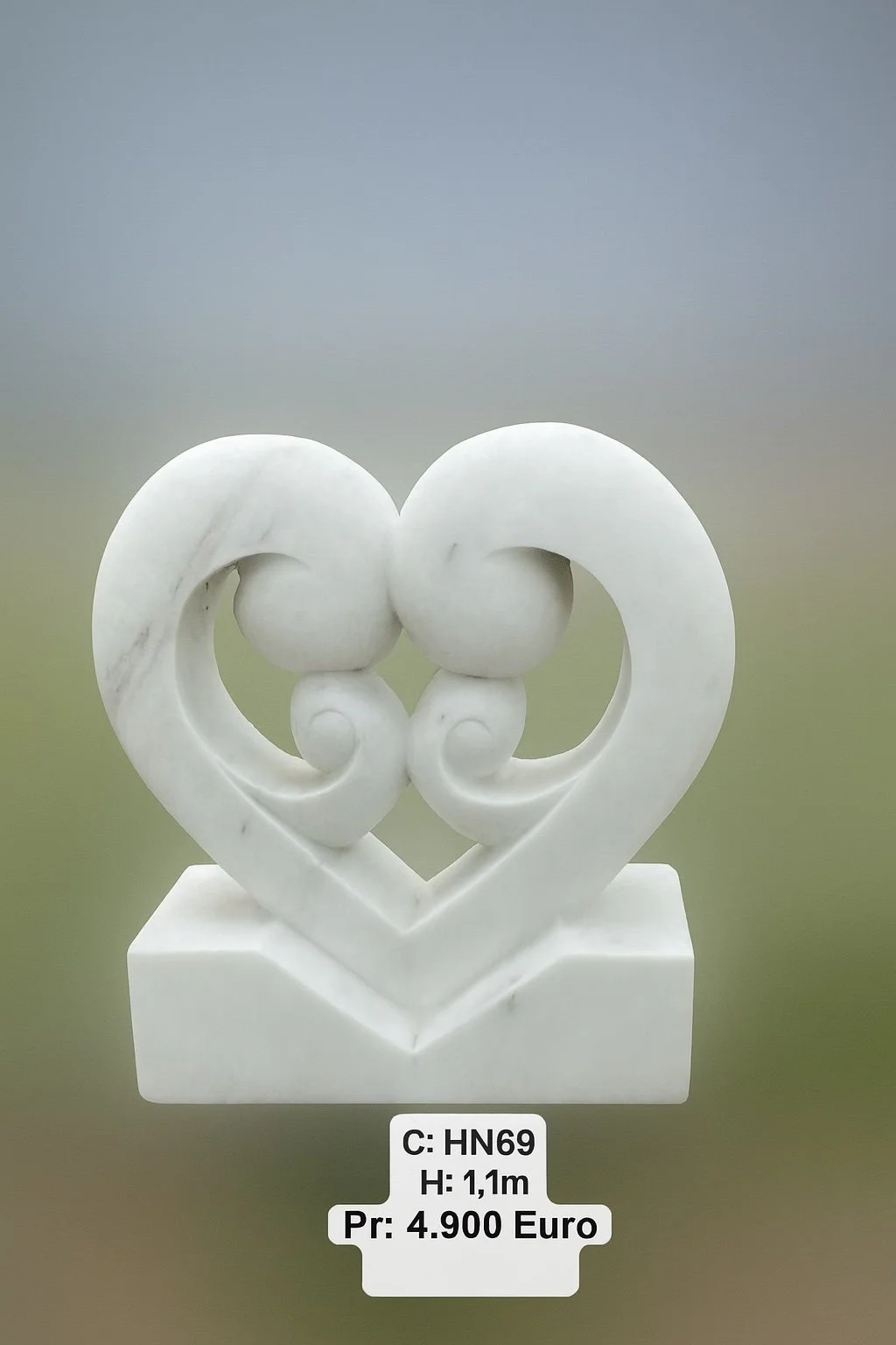 White marble sculpture of two intertwined hearts on a rectangular base.