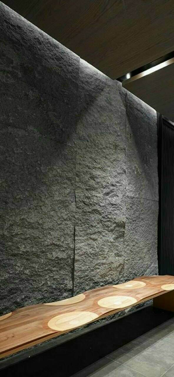 Modern interior with stone wall and wooden bench