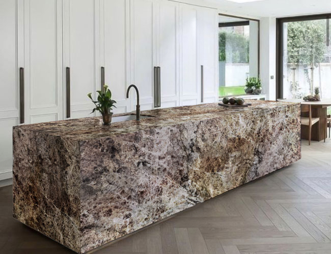 Modern kitchen with large stone island, white cabinets, wooden floor