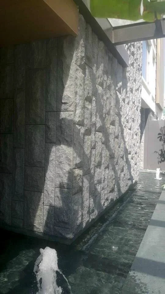 Stone wall with water feature and reflections