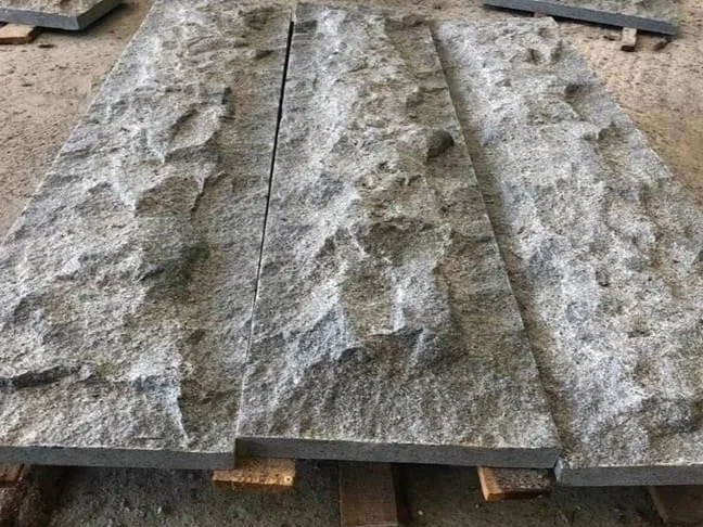 three rough granite slabs on wooden support