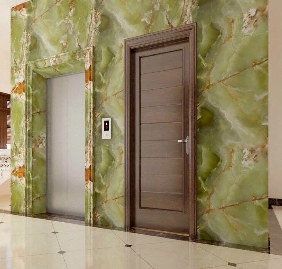 Modern interior with green marble wall, wooden door, and elevator entrance