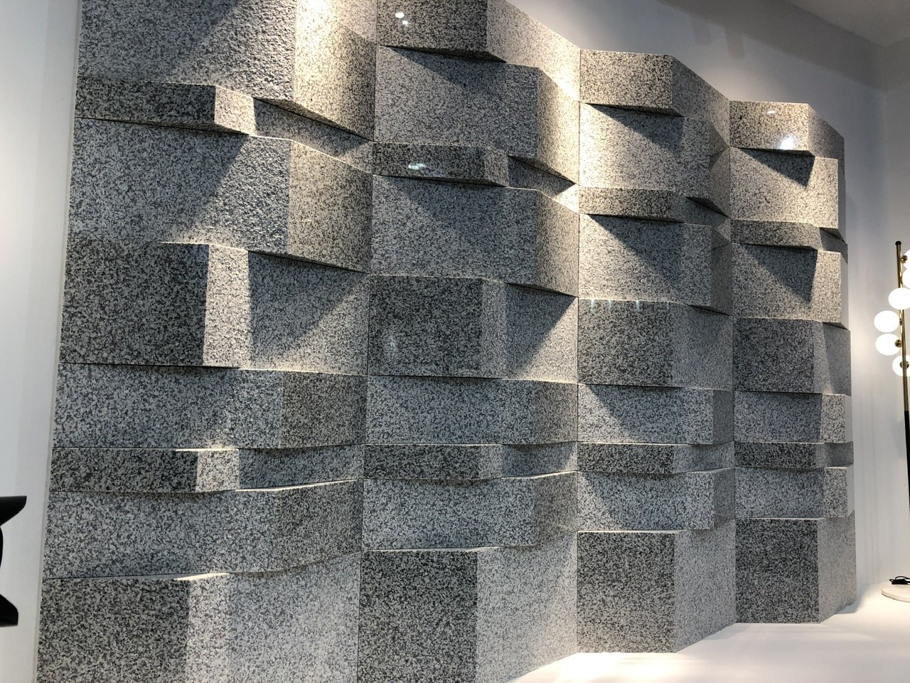 textured concrete wall with square layers and modern lighting
