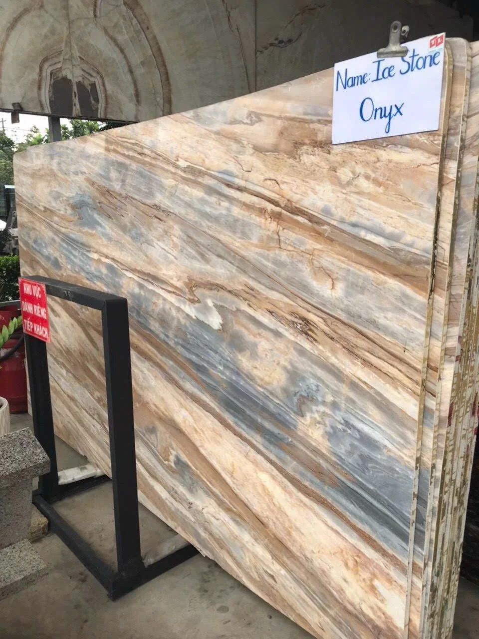Slabs of Ice Stone Onyx marble on display in a stone yard.