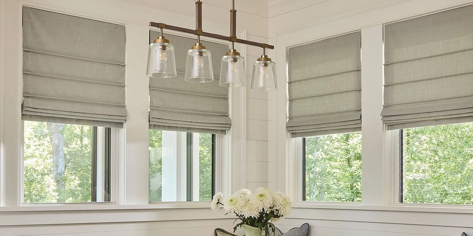 Carole Fabrics Roman shades in a dining room