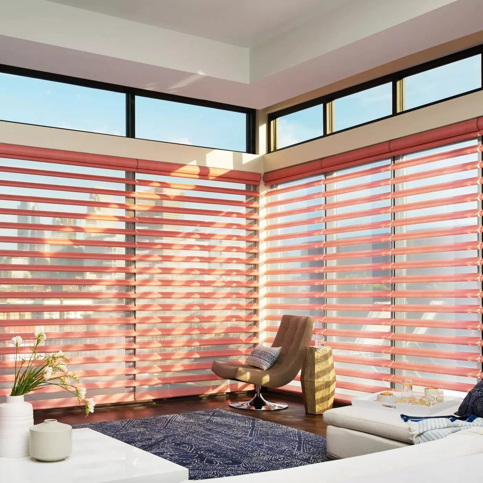 Hunter Douglas Pirouette window shadings in a coral-accented room