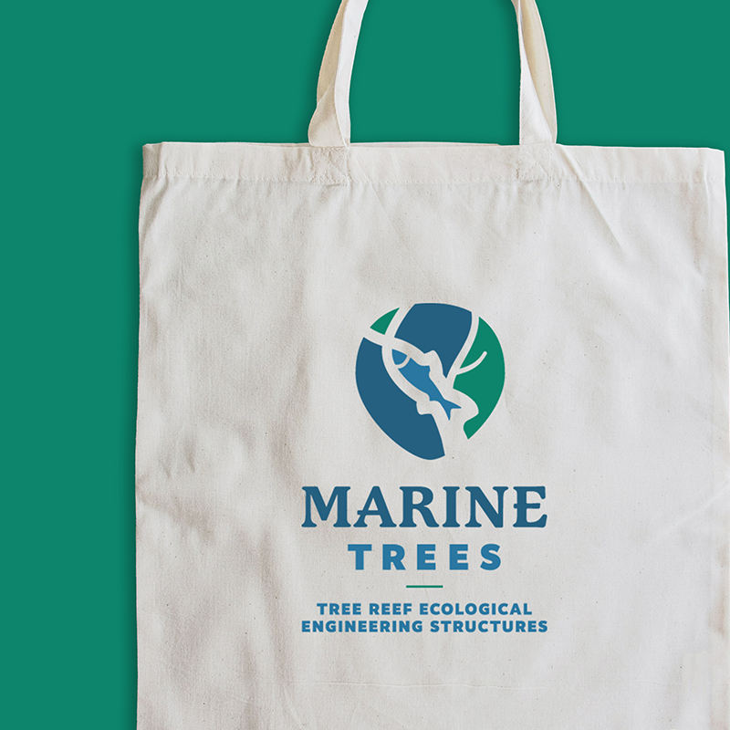 A cream tote bag branded with the Marine Trees logo