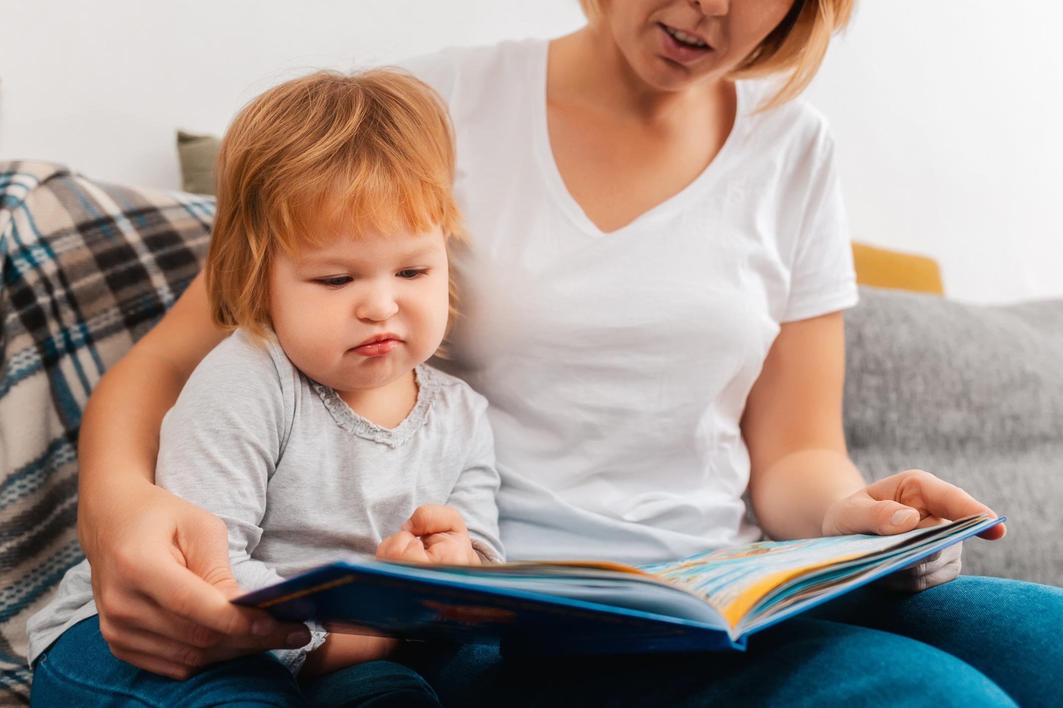 Speech-language pathologist coaching a parent during an in-home speech therapy session while a toddler participates in play-based communication activities in Leander, Texas.
