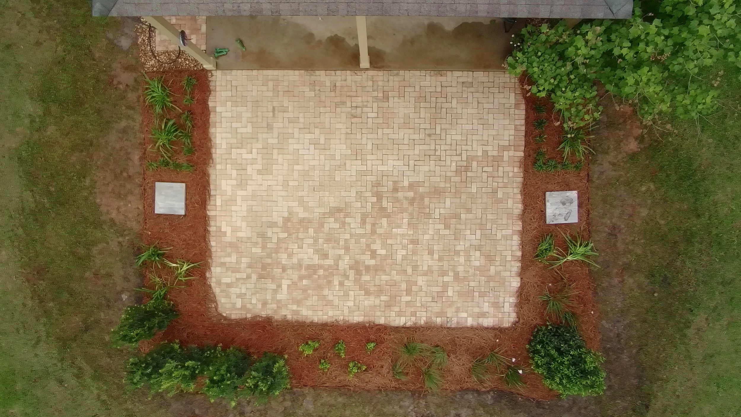 drone shot of paver patio with landscaping around it