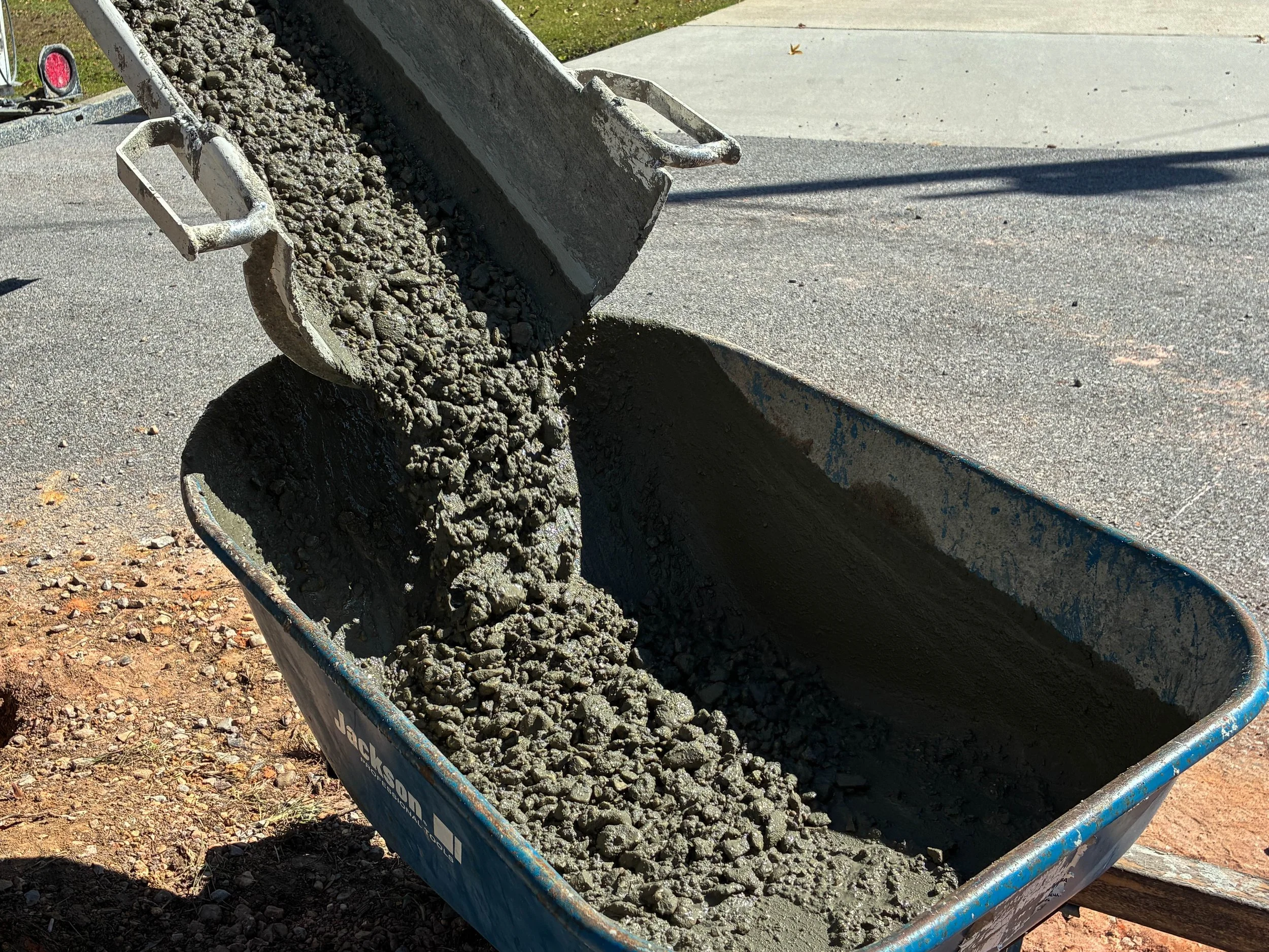 image of concrete pouring into a wheelbarrow