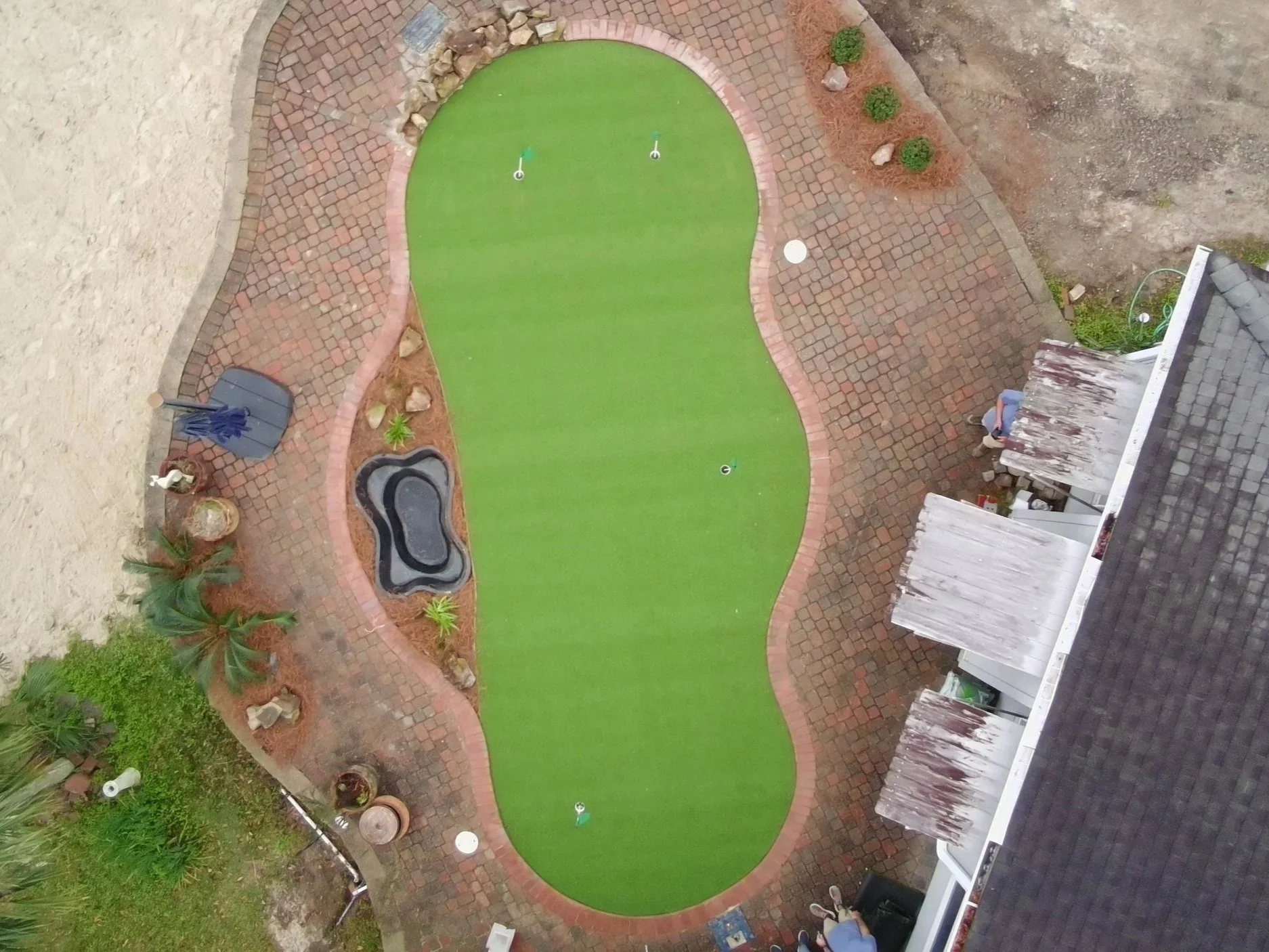 even higher, straight down drone picture of the putting greens