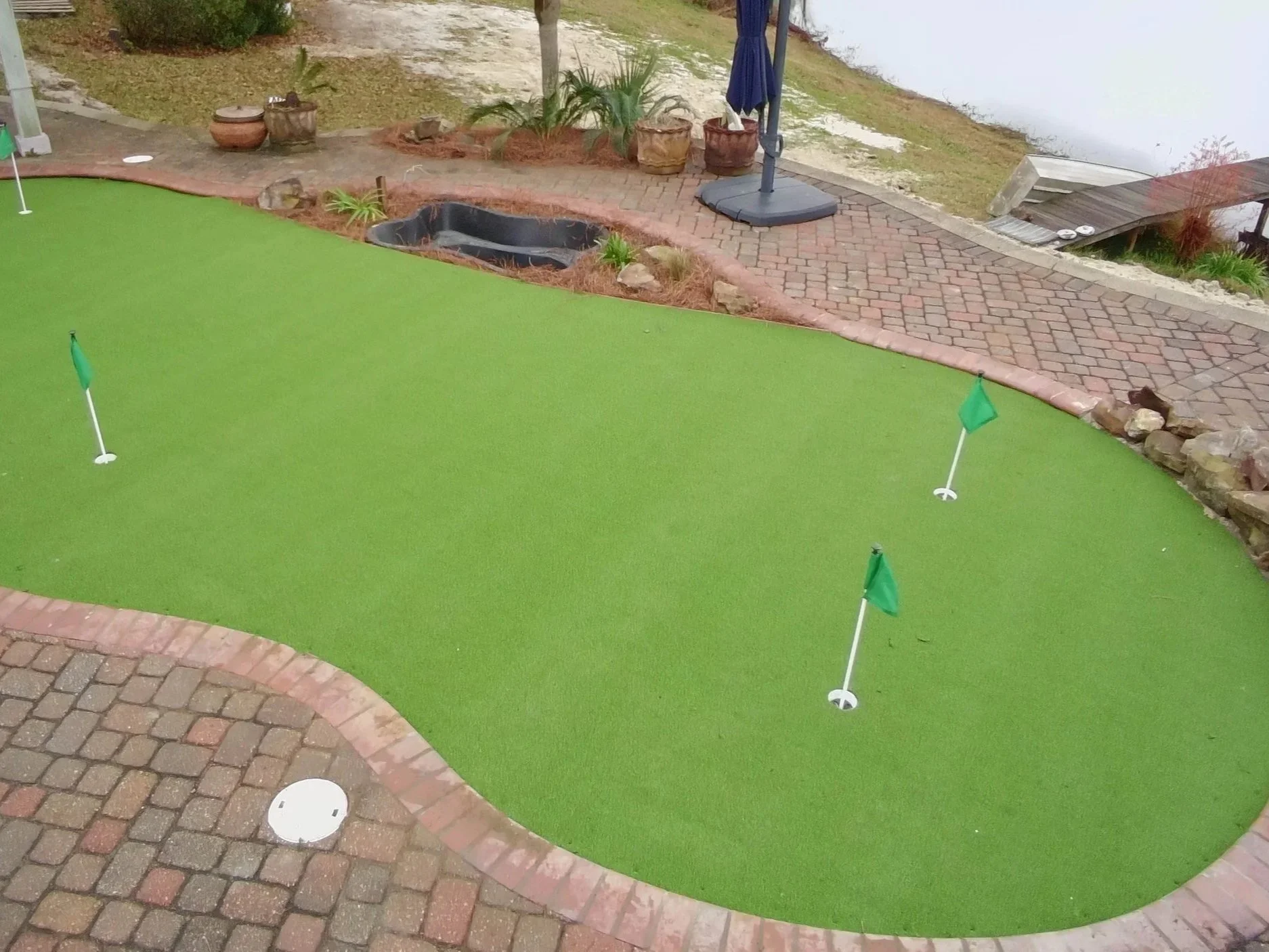 drone view of a pool that has been turned into putting greens